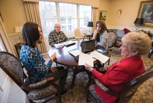 First year University of Rochester history PhD student Lauren Davis [bluish shirt] works with sophomore history and political science major Sarabeth Aranbold [grey sweater] and residents Lynn Nelson [red] and Allan Anderson [plaid] to transcribe letters for the Seward Family Papers Project at the Highlands in Pittsford, NY January 28, 2016. // photo by J. Adam Fenster / University of Rochester