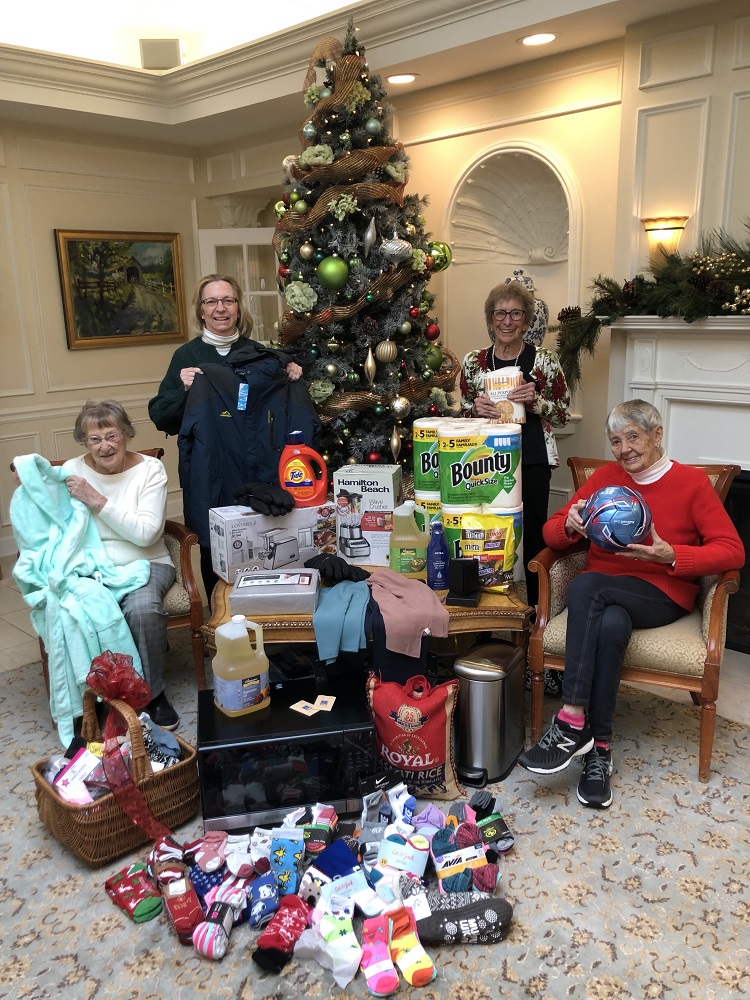Members of The Highlands at Pittsford Community Outreach Committee with gifts for our adopted family