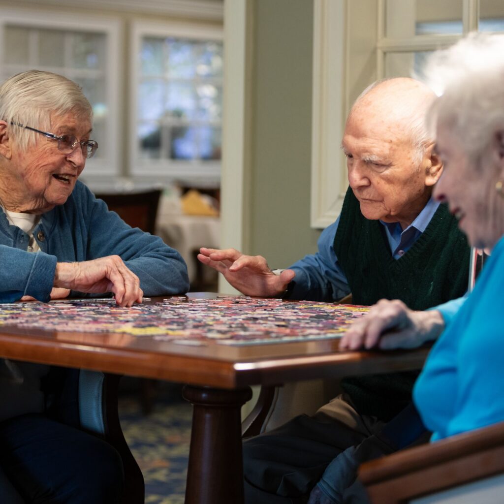 Group of Laurelwood residents working on a puzzle