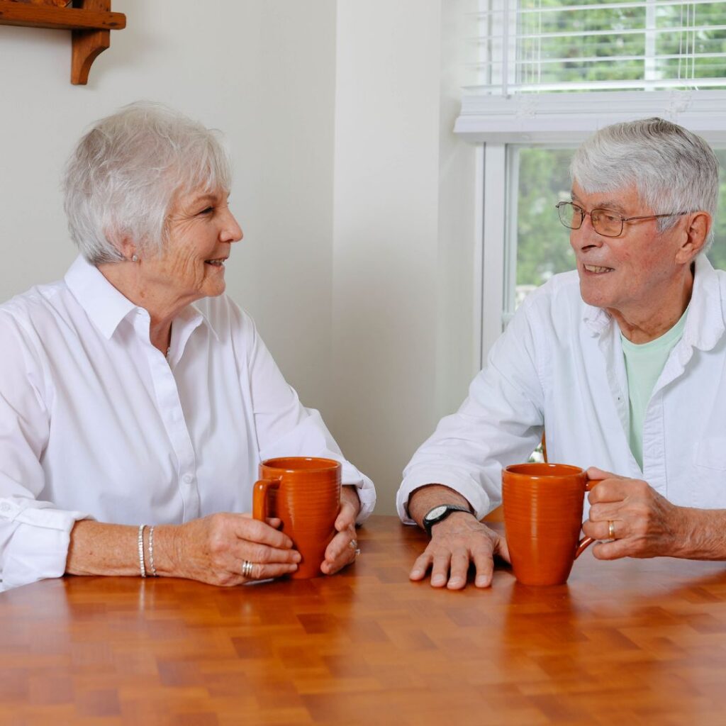 HAP-Cottages-Next-Level-Amenties A smiling couple enjoying coffee in the kitchen of their cottage residence